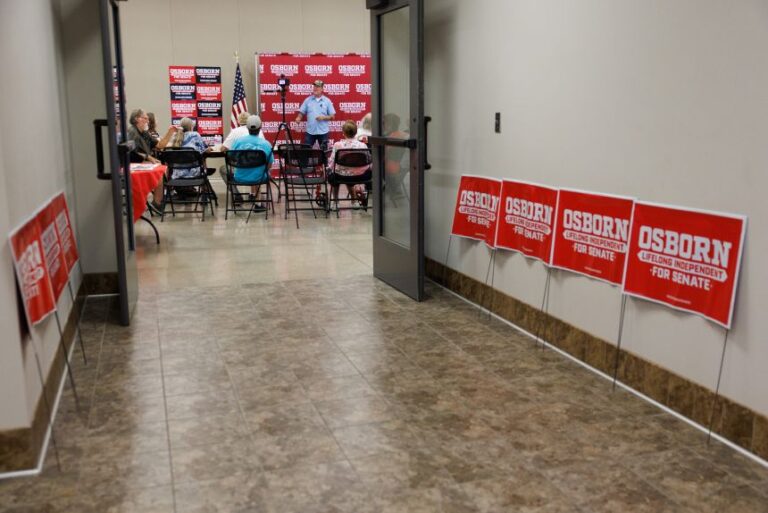 Signs for Dan Osborn are seen during a town hall at the Stastny Community Center in Hebron, Nebraska, on August 2.