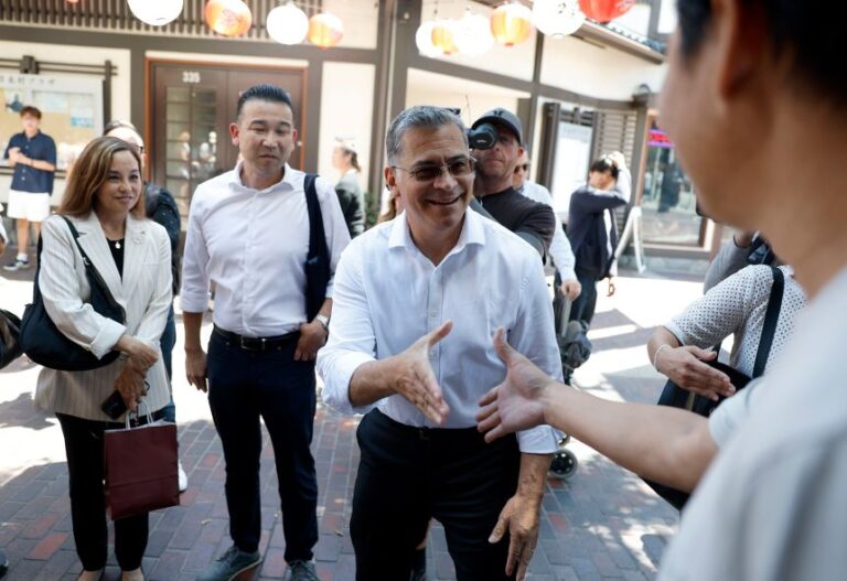 California Democratic gubernatorial candidate Xavier Becerra greets people as he tours Little Tokyo in Los Angeles, on August 18.