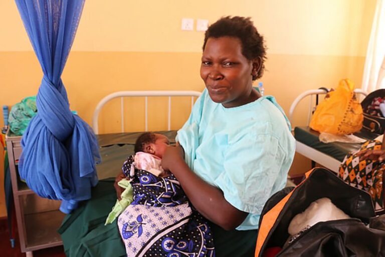 In this 2017 photo taken by USAID, a mother nurses a baby in a hospital in Kenya that received PEPFAR investments to help reduce mother-to-child transmission of HIV.