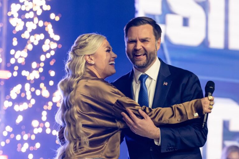Erika Kirk greets Vice President JD Vance during Turning Point USA's AmericaFest in Phoenix on December 21, 2025.