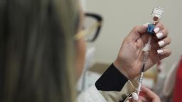Pharmacy manager Aylen Amestoy draws a dose of respiratory syncytial virus (RSV) vaccine into a syringe as she prepares a shot for a patient at a CVS Pharmacy in Miami, in 2025.