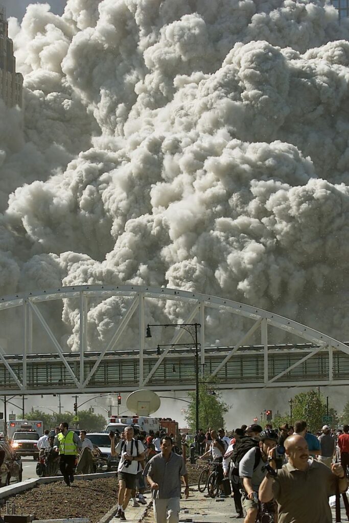 Dust and debris fill the air as one of the World Trade Center towers collapses.