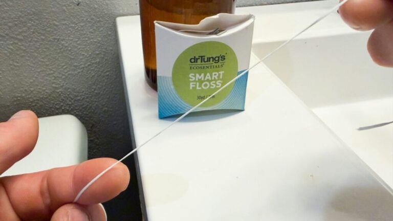 Person holding DrTung's Smart Floss.