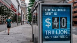 A view of a bus shelter at 13th and I St's NW where an electronic billboard and a poster display the current U.S. National debt per person and as a nation at 40 Trillion Dollars on August 30, 2026 in Washington, DC.