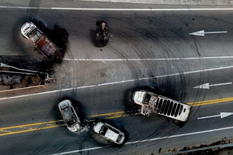 This aerial view shows burned cars and trucks, allegedly set on fire by criminal groups, on a highway near Acatlan de Juarez, Jalisco state, Mexico on February 22, 2026.