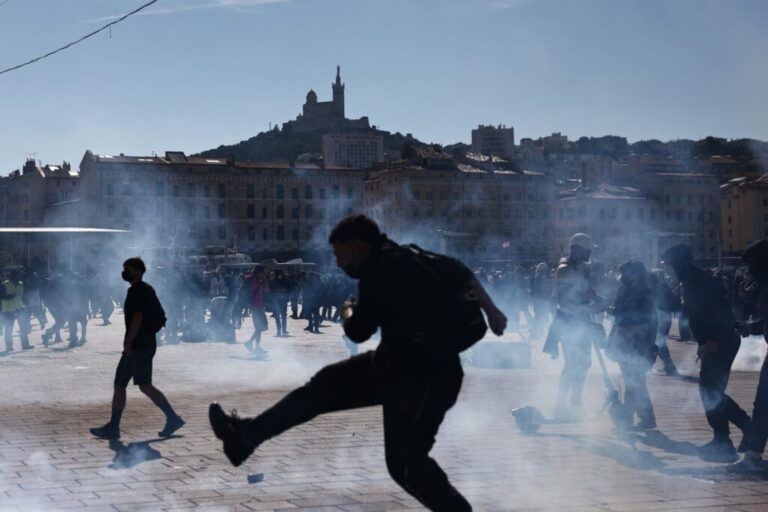 A protester kicks back a tear gas canister during a demonstration in Marseille on Saturday.