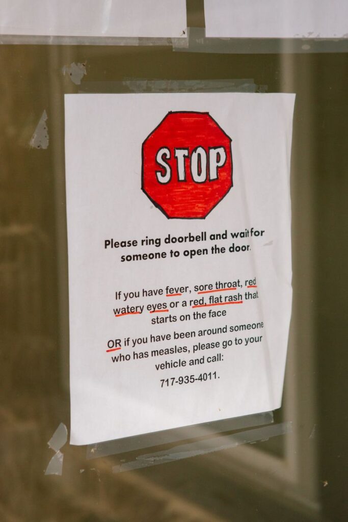 The rear entrance to the clinic building has become a makeshift triage center for people with suspected measles cases.