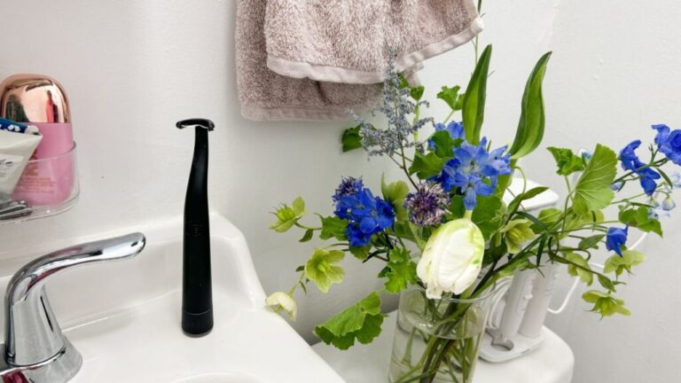 Flaus Electric Flosser Starter Kit next to the bathroom sink.