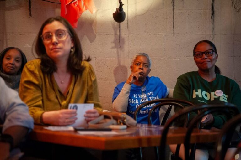 Toni Cooley, center, listens to Colom speak at the Apothecary at Brent's Drugs.