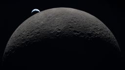 art002e009287 (April 6, 2026) – Earth sets at 6:41 p.m. EDT, April 6, 2026, over the Moon’s curved limb in this photo captured by the Artemis II crew during their journey around the far side of the Moon. Orientale basin is perched on the edge of the visible lunar surface. Hertzsprung Basin appears as two subtle concentric rings, which are interrupted by Vavilov, a younger crater superimposed over the older structure. The lines of indentations are secondary crater chains formed by ejecta from the massive impact that created Orientale.
The dark portion of Earth is experiencing nighttime. On Earth’s day side, swirling clouds are visible over the Australia and Oceania region.