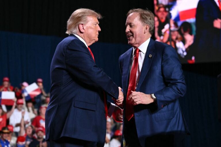 President Donald Trump shakes hands with Ken Paxton during a campaign rally in San Antonio on October 7.