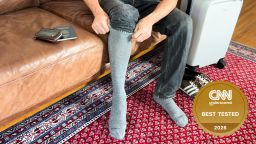 Man putting on Bombas Travel Compression Socks