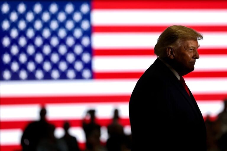 President Donald Trump stands on stage during a campaign rally for Oklahoma Republican gubernatorial candidate Mike Mazzei on October 1, in Durant, Oklahoma.