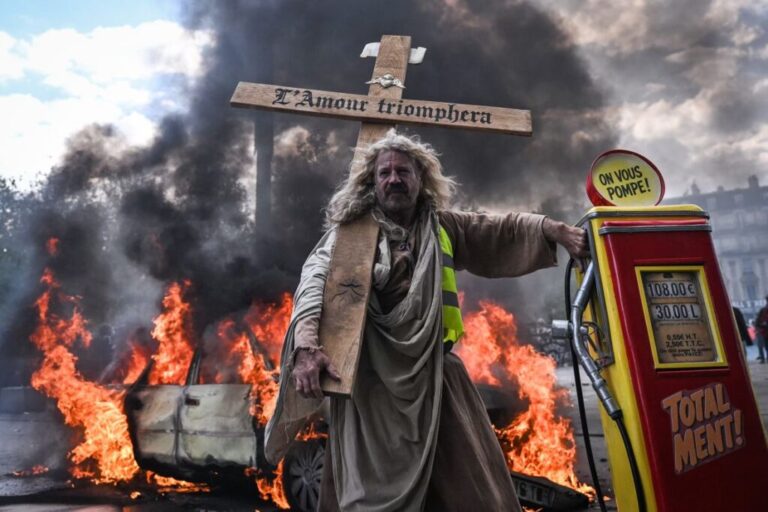 Protesters march through central Paris amid fires and smoke in Paris on Saturday.