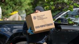Homeland Security officers carry boxes from the Washington, DC, residence of US Rep. Ilhan Omar during a search on Monday.