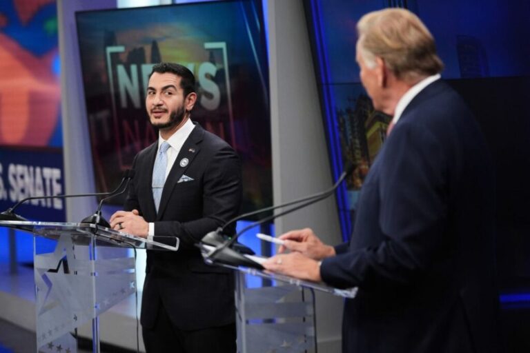 Democratic nominee for US Senate Abdul El-Sayed, left, looks over to Republican nominee Senate Mike Rogers during a televised debate at WOOD-TV, on October 8, in Grand Rapids, Michigan.