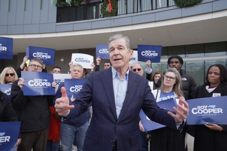 Democratic former Gov. Roy Cooper, who is running for US Senate, speaks to reporters after casting his ballot on the first day of in-person early voting in the state's primary election, on February 12, in Raleigh, N.C.