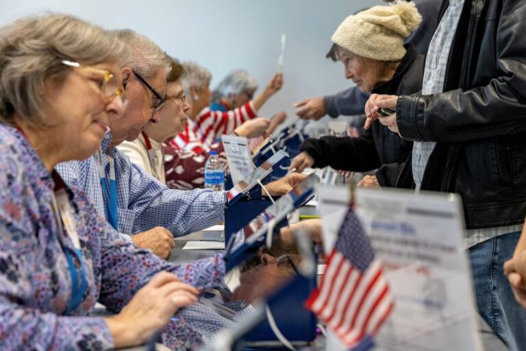 People prepare to cast their ballots during first day of early voting in Kansas City, Kansas, on Saturday.