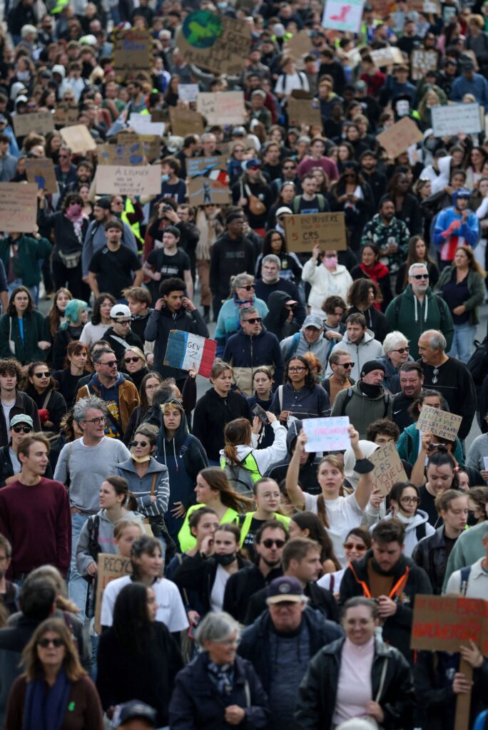 Protesters hold signs during a demonstration in Nantes on Saturday.