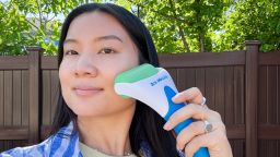 Woman using Esarora ice roller on her face