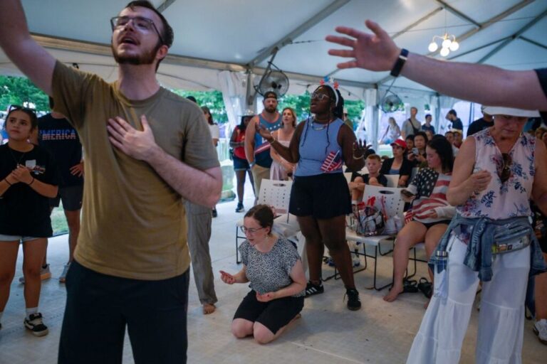 People pray and sing at the Great American State Fair on the National Mall in Washington, DC, on July 4.