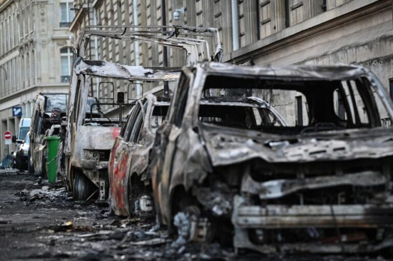 A photograph shows burnt vehicles in the street of Paris on Sunday.