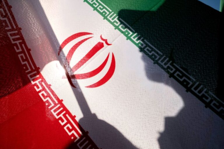 An Islamic Revolutionary Guard Corps (IRGC) personnel holds an Iranian national flag while preparing to take part in a military parade of Iran's ''self-sacrificing'' forces, organized and held by the Islamic Revolutionary Guard Corps (IRGC) in southern Tehran, Iran, on September 18.