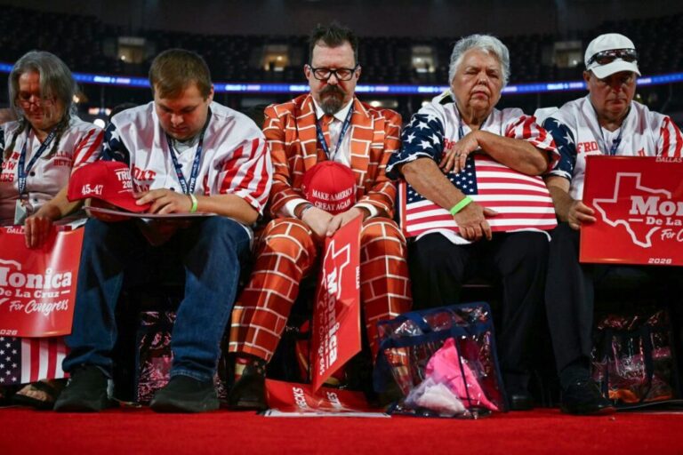 Attendees bow their heads during prayer on the first day of the Republican midterm convention in Dallas on September 9.