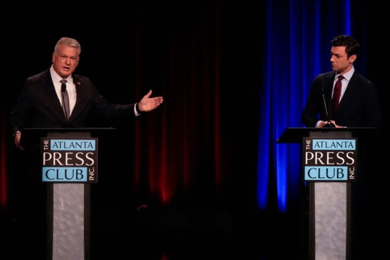 U.S. Rep. Mike Collins, R-Ga., left, speaks to U.S. Sen. Jon Ossoff, D-Ga., during an Atlanta Press Club general election senatorial debate, Tuesday, Oct. 13, 2026, in Atlanta. (AP Photo/Mike Stewart)