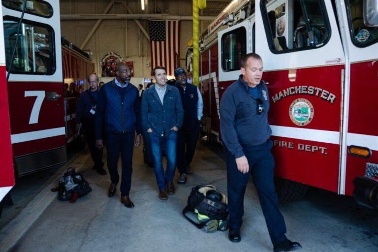 Manchester Fire Chief Ryan Cashin, right, leads Sen. Raphael Warnock and Chris Pappas on a tour of Manchester Fire Department Station 7 on October 6.