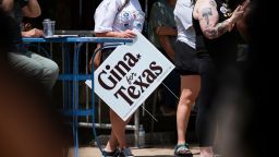 A supporter holds a sign for Democratic candidate for Texas governor Gina Hinojosa while she speaks during a rally in Lubbock, Texas, on July 18, 2026.