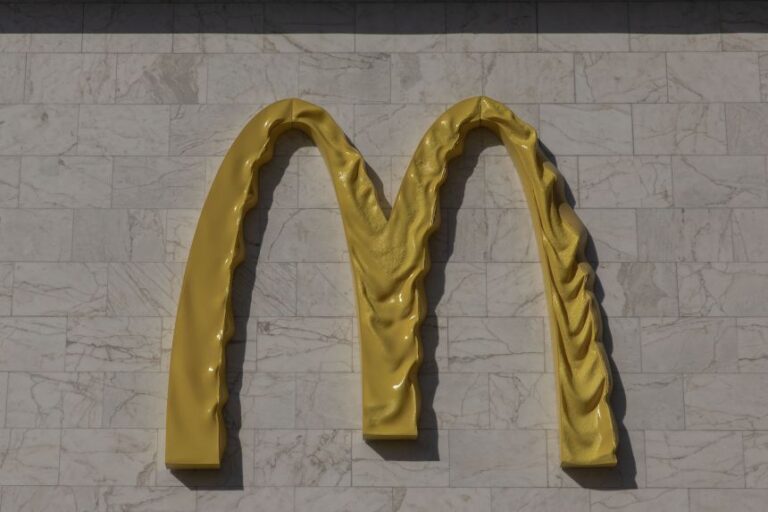 This photograph shows a McDonald's logo displayed on the facade of one of its restaurants, damaged and melted by Russian strikes near the Lukianivska metro station in Kyiv on May 27, 2026.