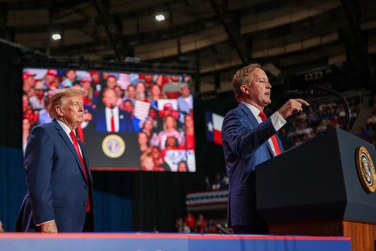 President Donald Trump listens as Republican Senate candidate and Texas Attorney General Ken Paxton speaks during a campaign rally in San Antonio, on Wednesday.