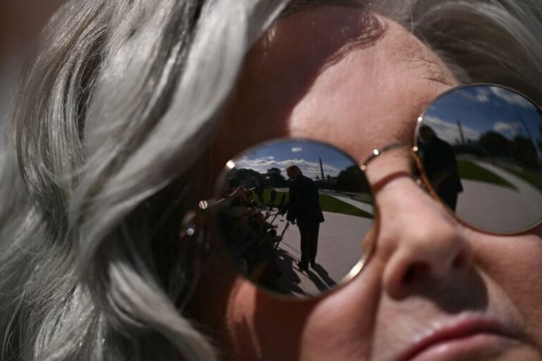 President Donald Trump is reflected in the sunglasses of White House chief of staff Susie Wiles as he speaks to the press on the South Lawn of the White House on October 5.