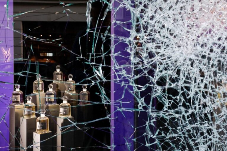 A vandalized storefront a day after clashes during a national day of demonstrations in Paris on Sunday.