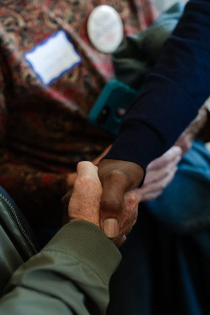 Sen. Raphael Warnock shakes hands with a voter in Nashua, New Hampshire, on October 6.