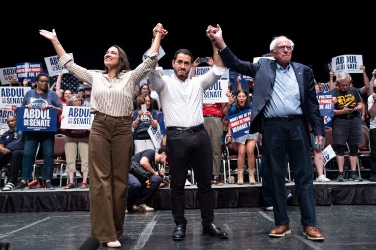 Rep. Alexandria Ocasio-Cortez, left, Democratic candidate for Senate Abdul El-Sayed, center, and Sen. Bernie Sanders greet the crowd after El-Sayed spoke at The People V. The Powerful rally at the Detroit Opera House in Detroit on July 18, 2026