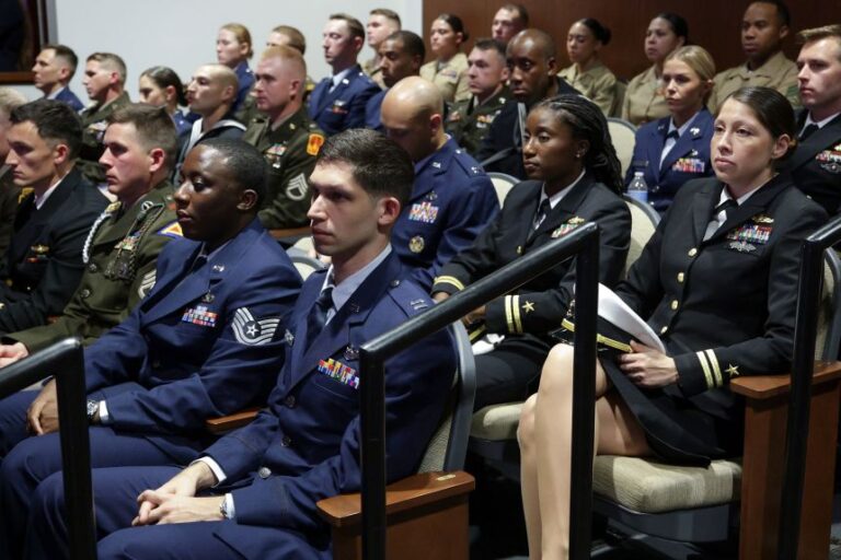 Members of the military listen as US Secretary of Defense Pete Hegseth gives an address at Marine Corps Base Quantico on September 30, 2026 in Quantico, Virginia.